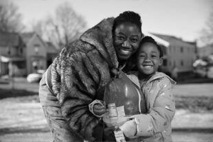 Mother and daughter smiling with groceries