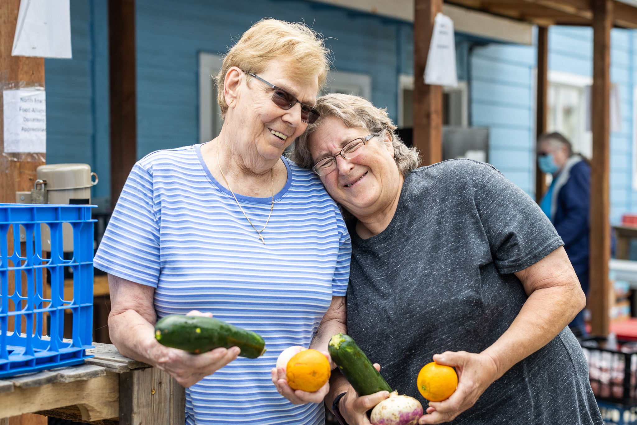 Ladies holding vegetables and laughing